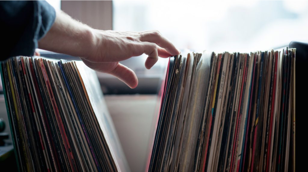 Person flipping through Vinyl records
