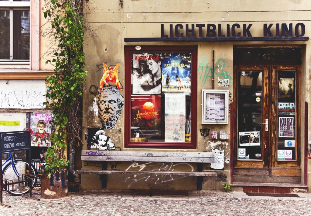 The entrance to Lichtblick Kino. Around the door and entrance there are many film posters and graffiti.