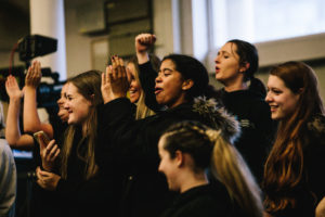 Students cheering and clapping together