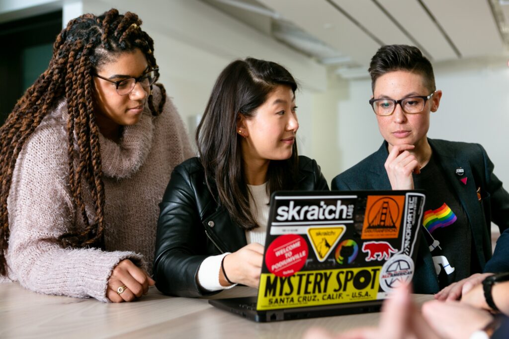 Team brainstorm around a laptop.