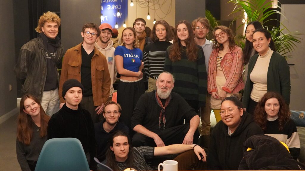 The group of BIMM University Berlin students from Music Production, Songwriting and Popular Music Performance surround singer, songwriter and composer Fink. Fink is crouching in the middle of the group.