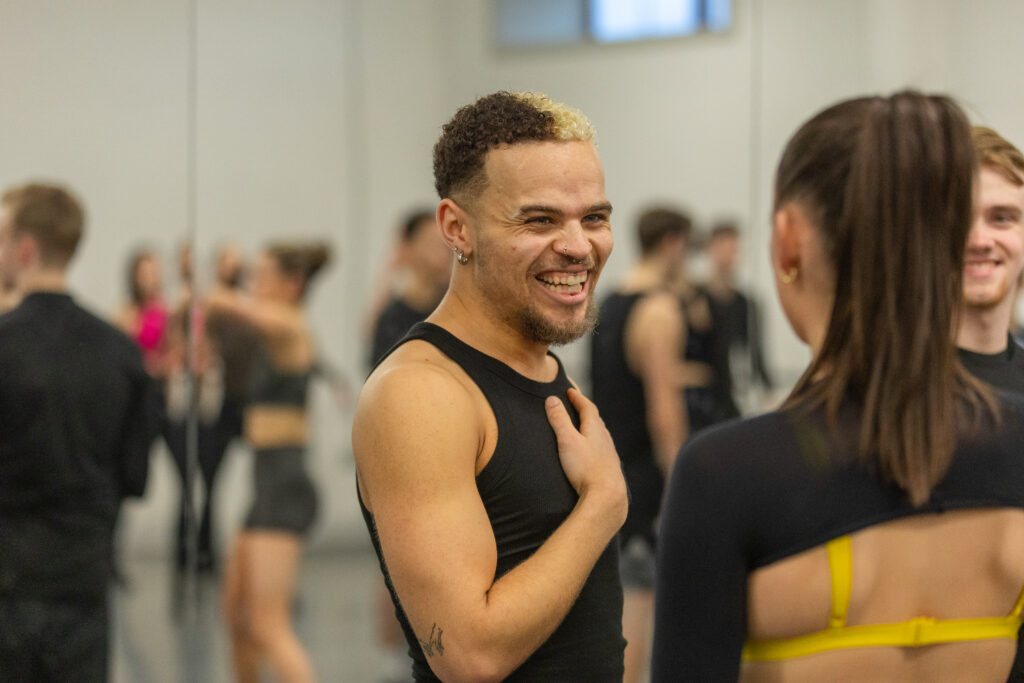 student smiles during rehearsals for Move IT