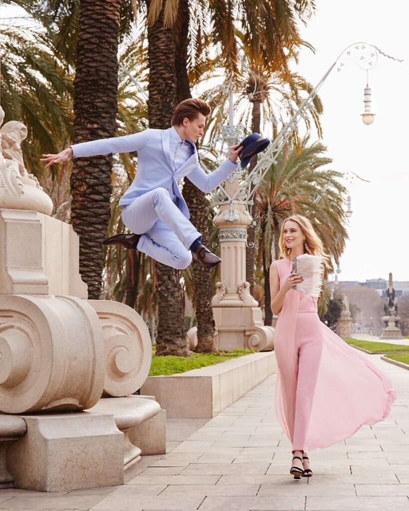 ellis is frozen in mid air as he leaps towards a womanw who is smiling