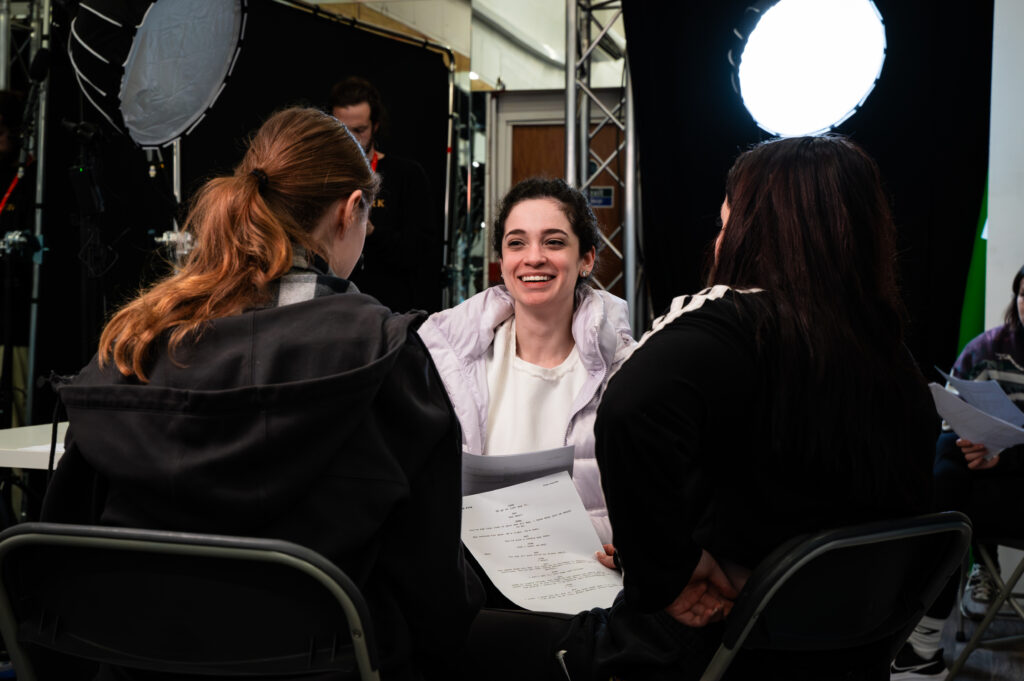 Camila smiles during discussion in class